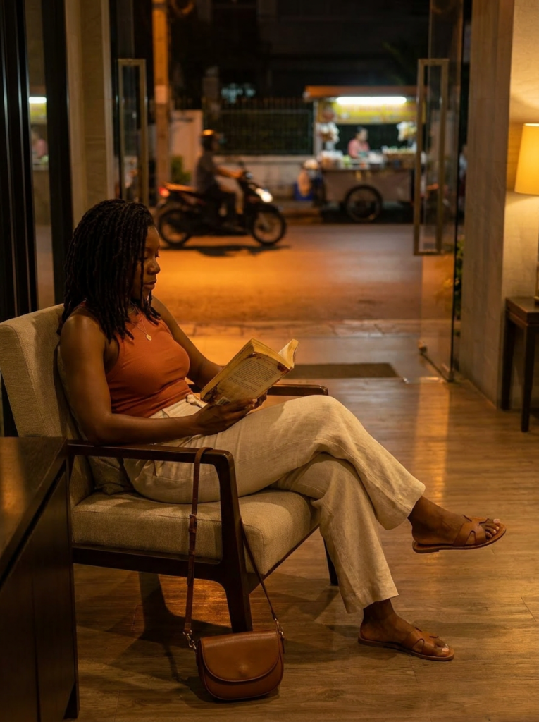 Trina Bookstore Trina reading a book in a Bangkok hotel lobby during a quiet evening of slow travel reflection